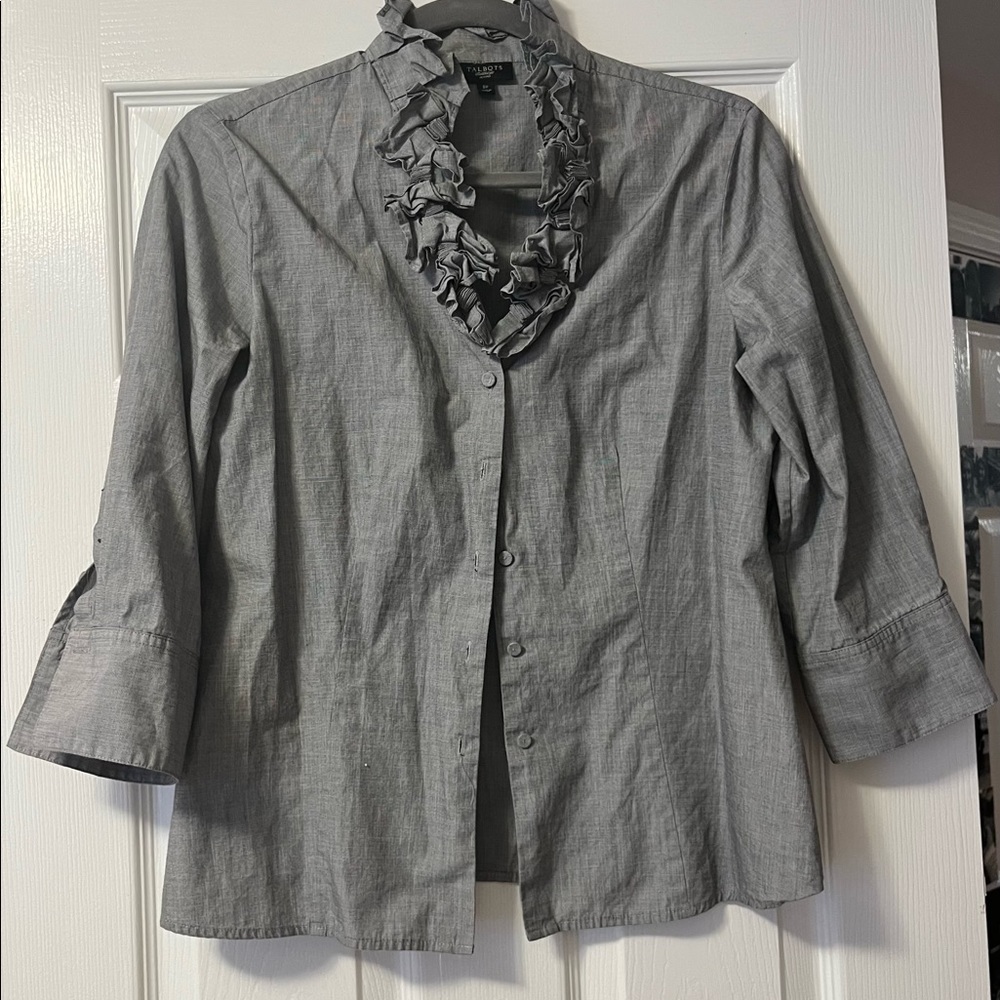 Button down gray blouse with mid length sleeves and ruffled neck line
